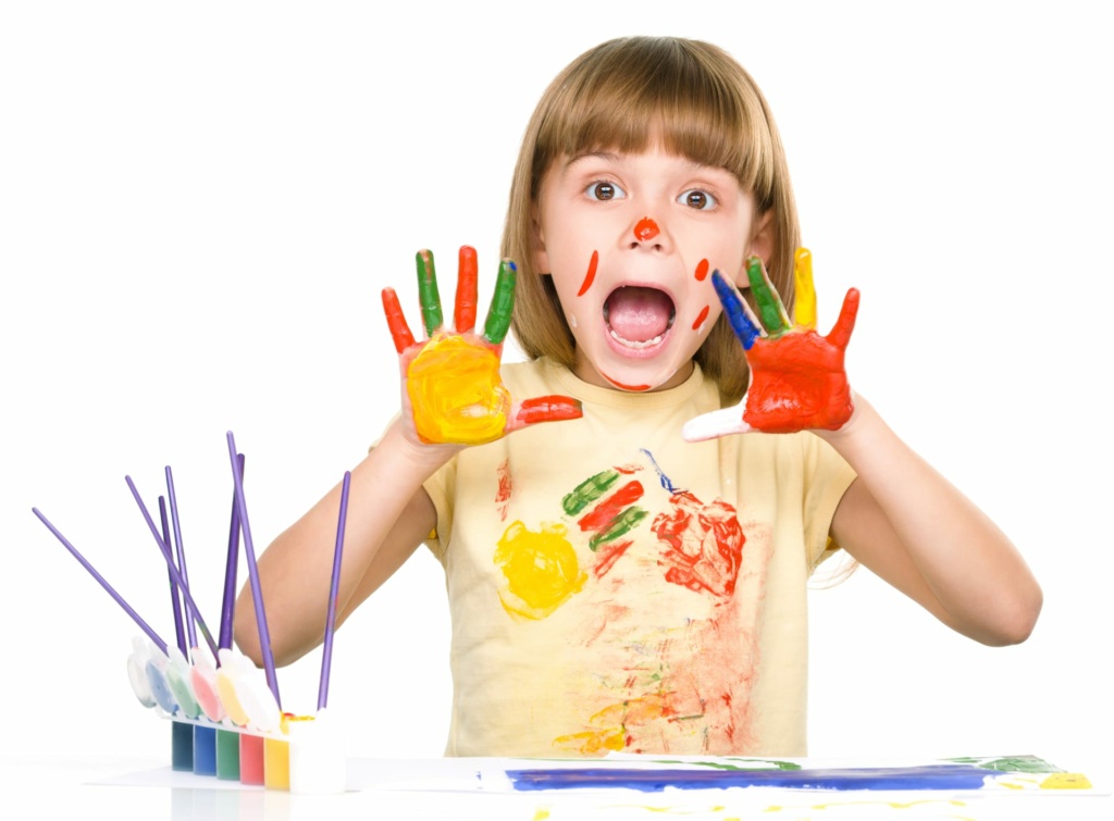 Cute girl playing with paints