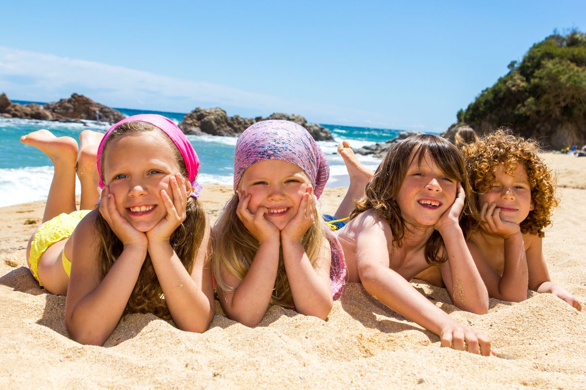 Kids laying on the beach